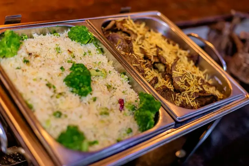 Cubas do bufê com arroz com brócolis e carne com batata palha